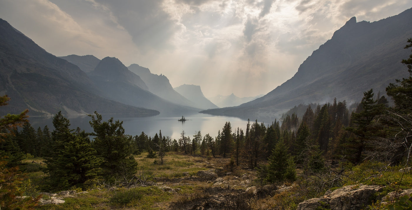 Panorama of Goose Island in Glacier National Park, including trees, lake, and mountains.