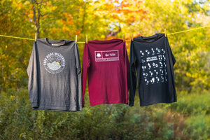 Seek More Wilderness Long Sleeves Arranged on Clothesline in Fall