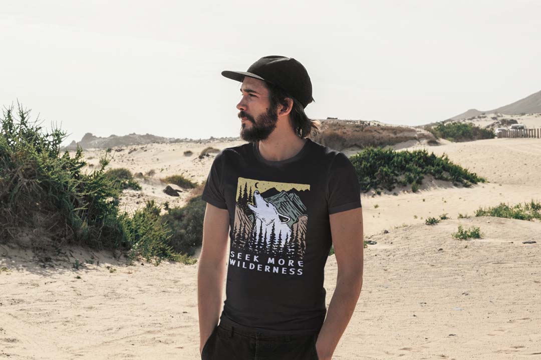 Man wearing black Wolf T-shirt at beach